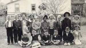 winter-2025-newsletter-154 group fo children with teacher on lawn dressed for Sunday School in 1940s.