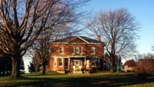 Red brick 2-storey house at sunset in late fall